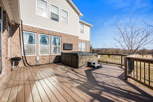 wooden deck with grilling area and a hot tub