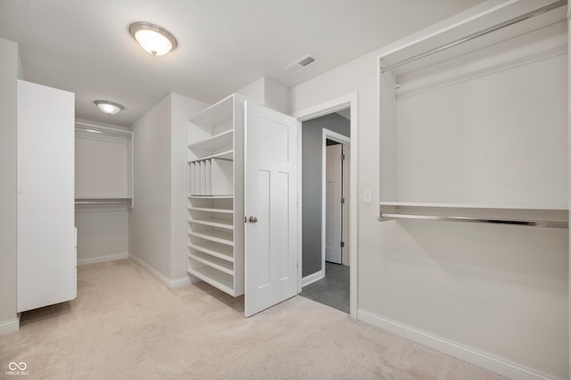 spacious closet featuring visible vents and carpet