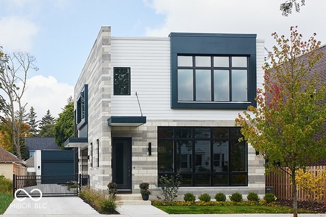 contemporary home featuring an outbuilding and a garage