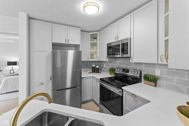 kitchen featuring sink, stainless steel appliances, and white cabinets