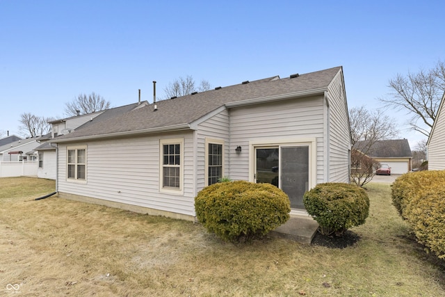 rear view of property featuring a lawn