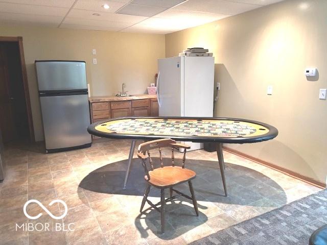 dining room featuring a drop ceiling