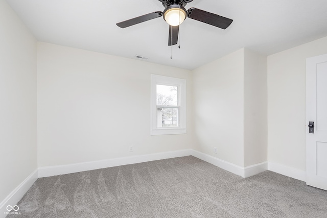 empty room with ceiling fan and carpet floors