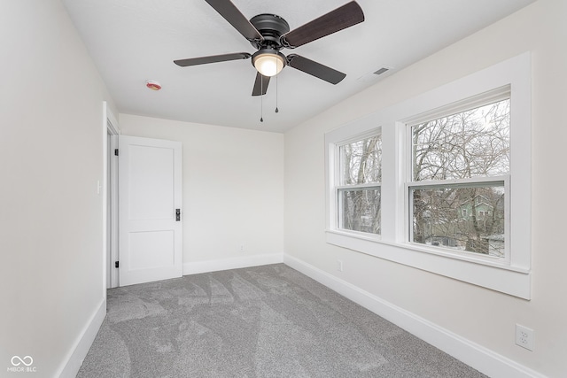 carpeted empty room featuring ceiling fan