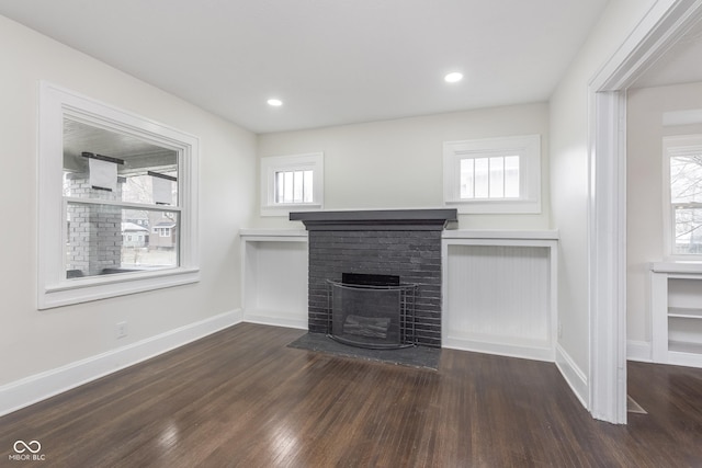 unfurnished living room featuring dark hardwood / wood-style floors and a fireplace