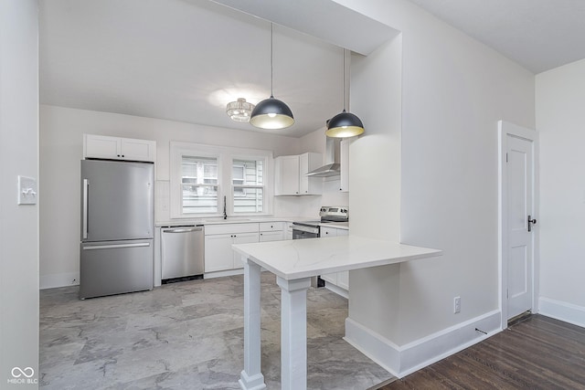 kitchen featuring white cabinetry, appliances with stainless steel finishes, sink, and pendant lighting