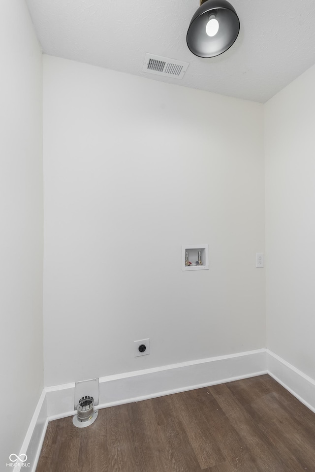 clothes washing area featuring hookup for a washing machine, wood-type flooring, and hookup for an electric dryer