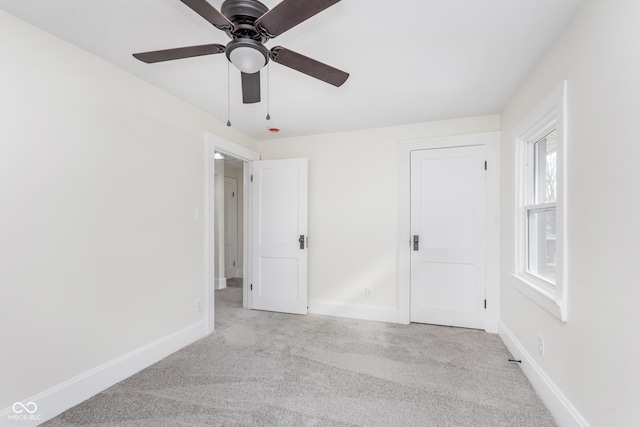 unfurnished bedroom with ceiling fan and light carpet