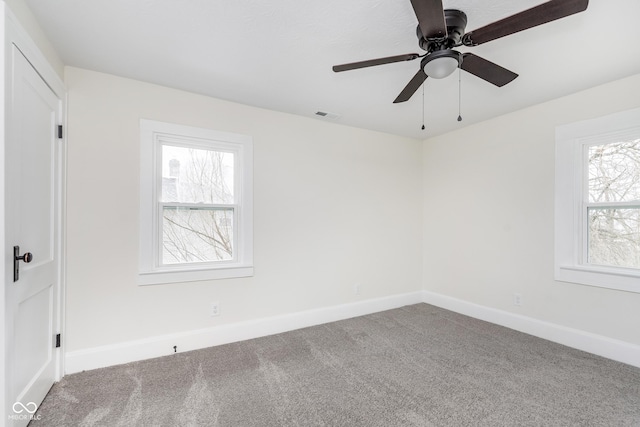 unfurnished room featuring ceiling fan and carpet flooring