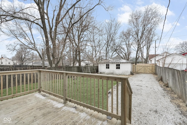 wooden terrace featuring a shed and a lawn