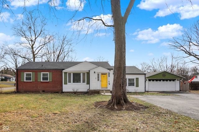 ranch-style house featuring a garage and a front lawn