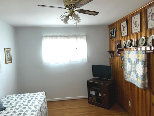 bedroom with ceiling fan and wood-type flooring