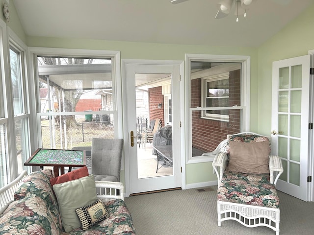 sunroom / solarium featuring a wealth of natural light, vaulted ceiling, and ceiling fan