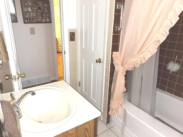 bathroom featuring tile patterned flooring, vanity, and shower / tub combo with curtain