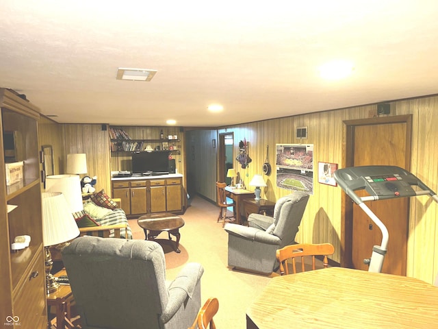 living room with wooden walls and light colored carpet