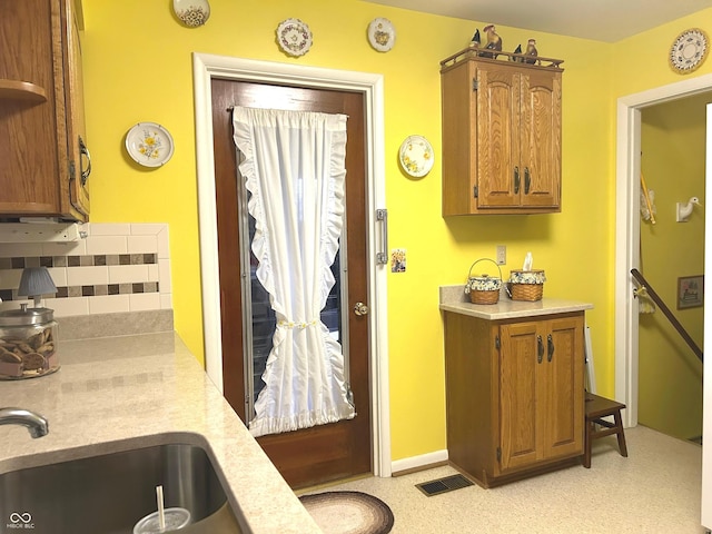 kitchen featuring tasteful backsplash and sink