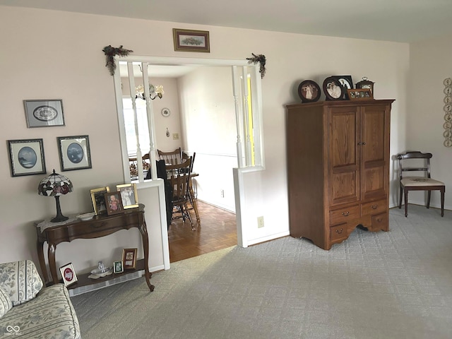 living area with light carpet and a notable chandelier