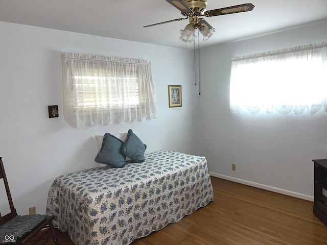 bedroom with hardwood / wood-style flooring and ceiling fan