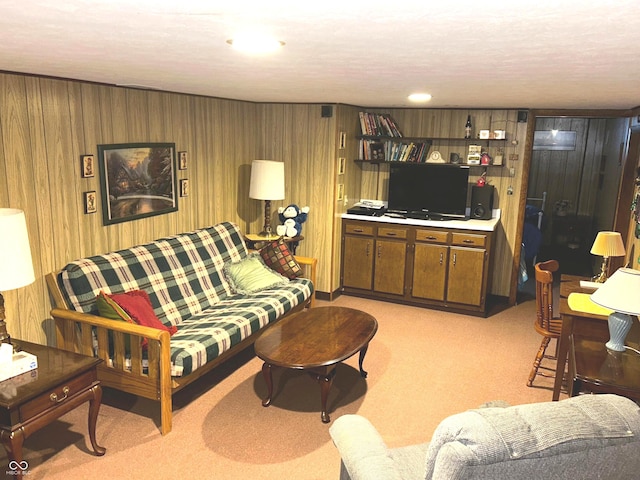 carpeted living room featuring wood walls