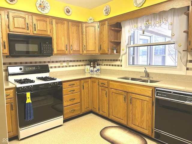 kitchen with tasteful backsplash, sink, and black appliances