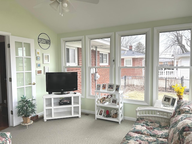 sunroom / solarium with ceiling fan and vaulted ceiling