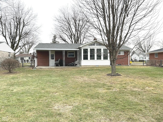 rear view of house with a yard