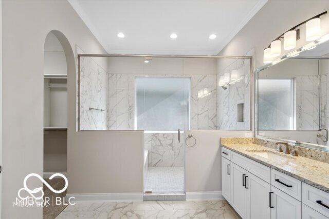 full bath featuring marble finish floor, a marble finish shower, recessed lighting, vanity, and baseboards