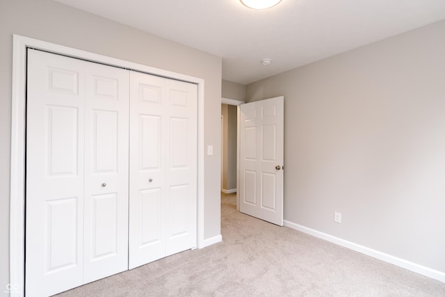 1305 W 23rd St, Indianapolis, IN 46208 - unfurnished bedroom featuring light carpet, a closet, and baseboards