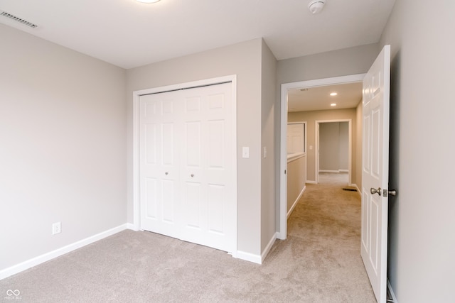 1305 W 23rd St, Indianapolis, IN 46208 - unfurnished bedroom featuring light carpet, a closet, baseboards, and recessed lighting