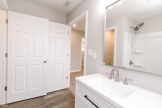 1305 W 23rd St, Indianapolis, IN 46208 - full bath featuring vanity, recessed lighting, a shower, and wood finished floors