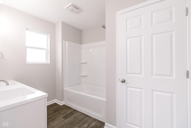 1305 W 23rd St, Indianapolis, IN 46208 - bathroom featuring wood finished floors, baseboards, bathtub / shower combination, and vanity