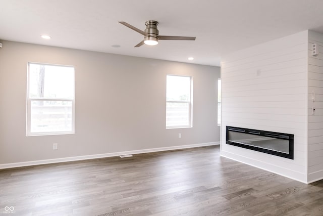 1305 W 23rd St, Indianapolis, IN 46208 - unfurnished living room with a large fireplace, ceiling fan, wood finished floors, recessed lighting, and baseboards