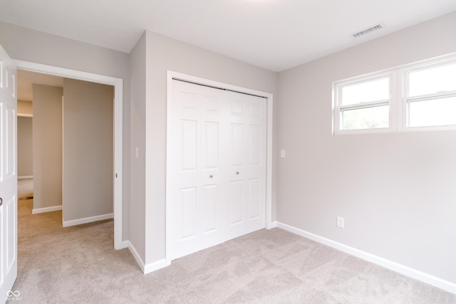 1305 W 23rd St, Indianapolis, IN 46208 - unfurnished bedroom with light carpet, a closet, and baseboards