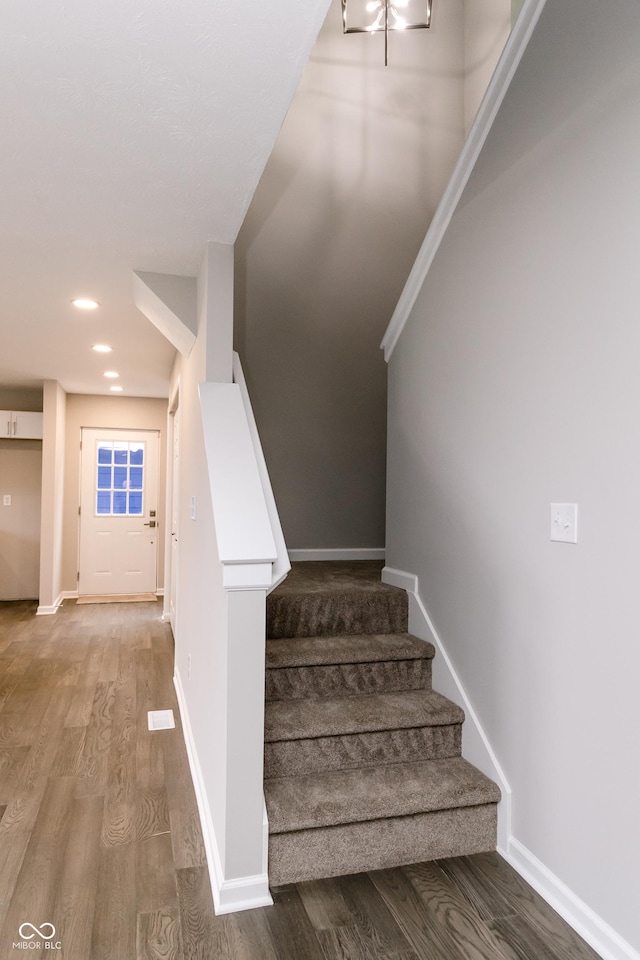 1305 W 23rd St, Indianapolis, IN 46208 - staircase featuring wood finished floors, baseboards, and recessed lighting