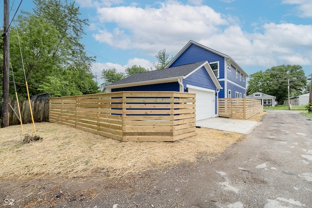 1305 W 23rd St, Indianapolis, IN 46208 - view of side of home with a garage and a shingled roof