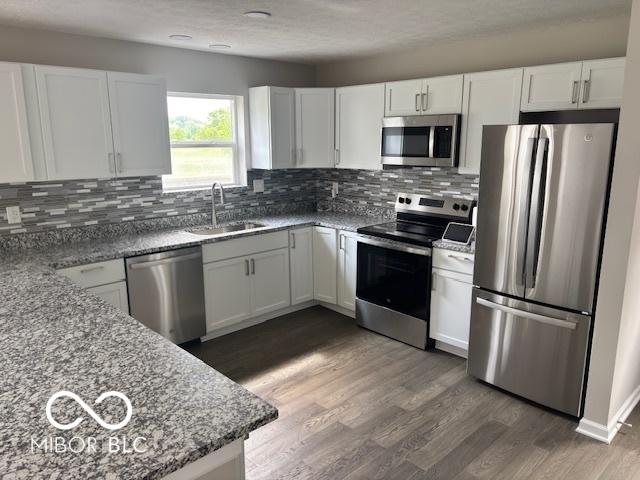 1305 W 23rd St, Indianapolis, IN 46208 - kitchen featuring appliances with stainless steel finishes, a sink, and white cabinetry