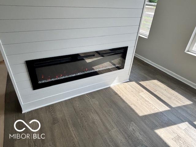1305 W 23rd St, Indianapolis, IN 46208 - detailed view of a glass covered fireplace, wood finished floors, and baseboards