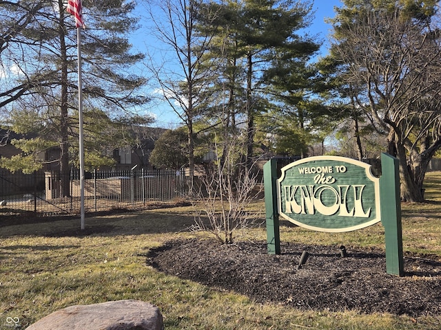 community / neighborhood sign with fence