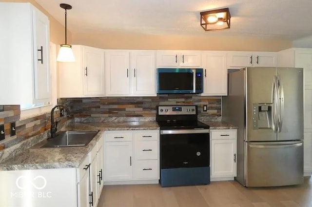 2847 Merts Dr, Indianapolis, IN 46237 - kitchen featuring stainless steel appliances, white cabinetry, sink, and pendant lighting