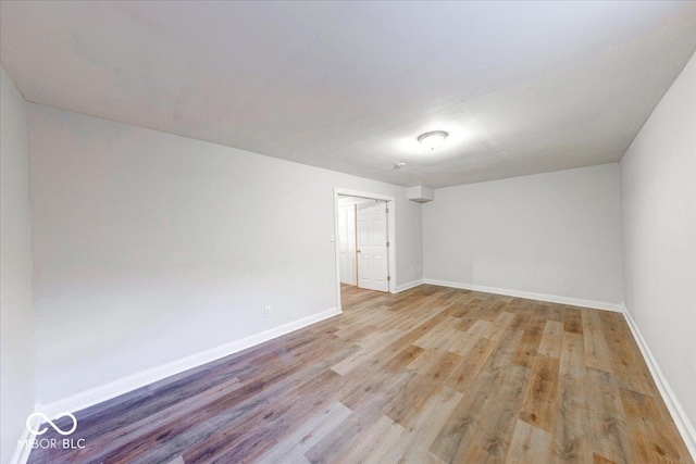 empty room featuring wood finished floors and baseboards