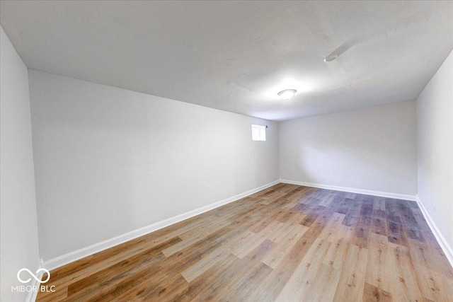 unfurnished room with wood finished floors and baseboards