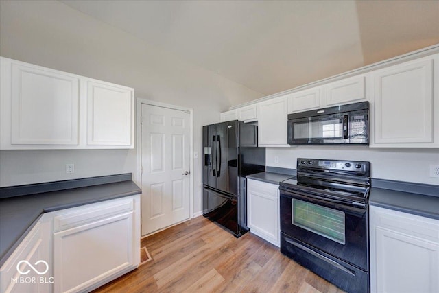 kitchen with white cabinetry, black appliances, and dark countertops