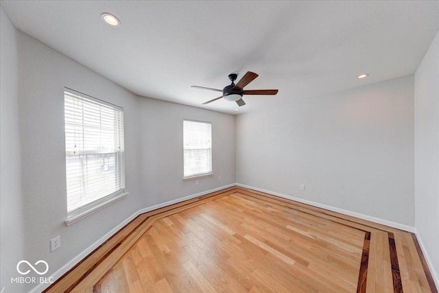 empty room with ceiling fan, baseboards, wood finished floors, and recessed lighting