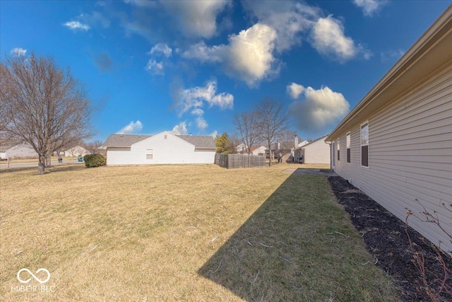 view of yard featuring fence and a residential view