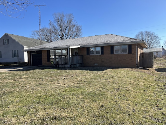 ranch-style house with a garage and a front lawn