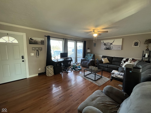 living room with ornamental molding, dark wood-type flooring, and ceiling fan