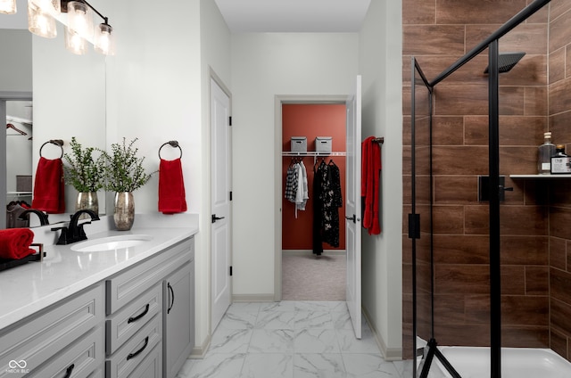 bathroom with vanity and a shower with door