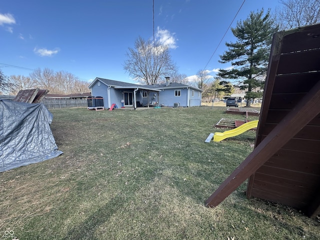 view of yard featuring a playground and fence