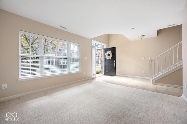 unfurnished living room featuring light colored carpet