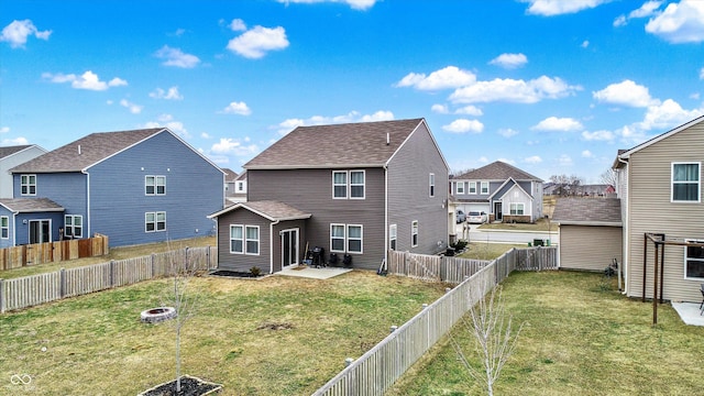 back of property featuring a yard, a patio area, and an outdoor fire pit